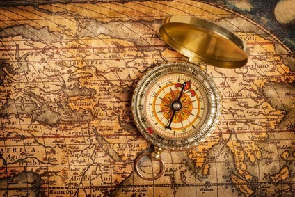 old-vintage-golden-compass-on-ancient-map_sizeXS