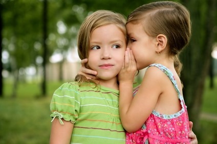 two-twin-little-sister-girls-whisper-in-ear_sizeXS